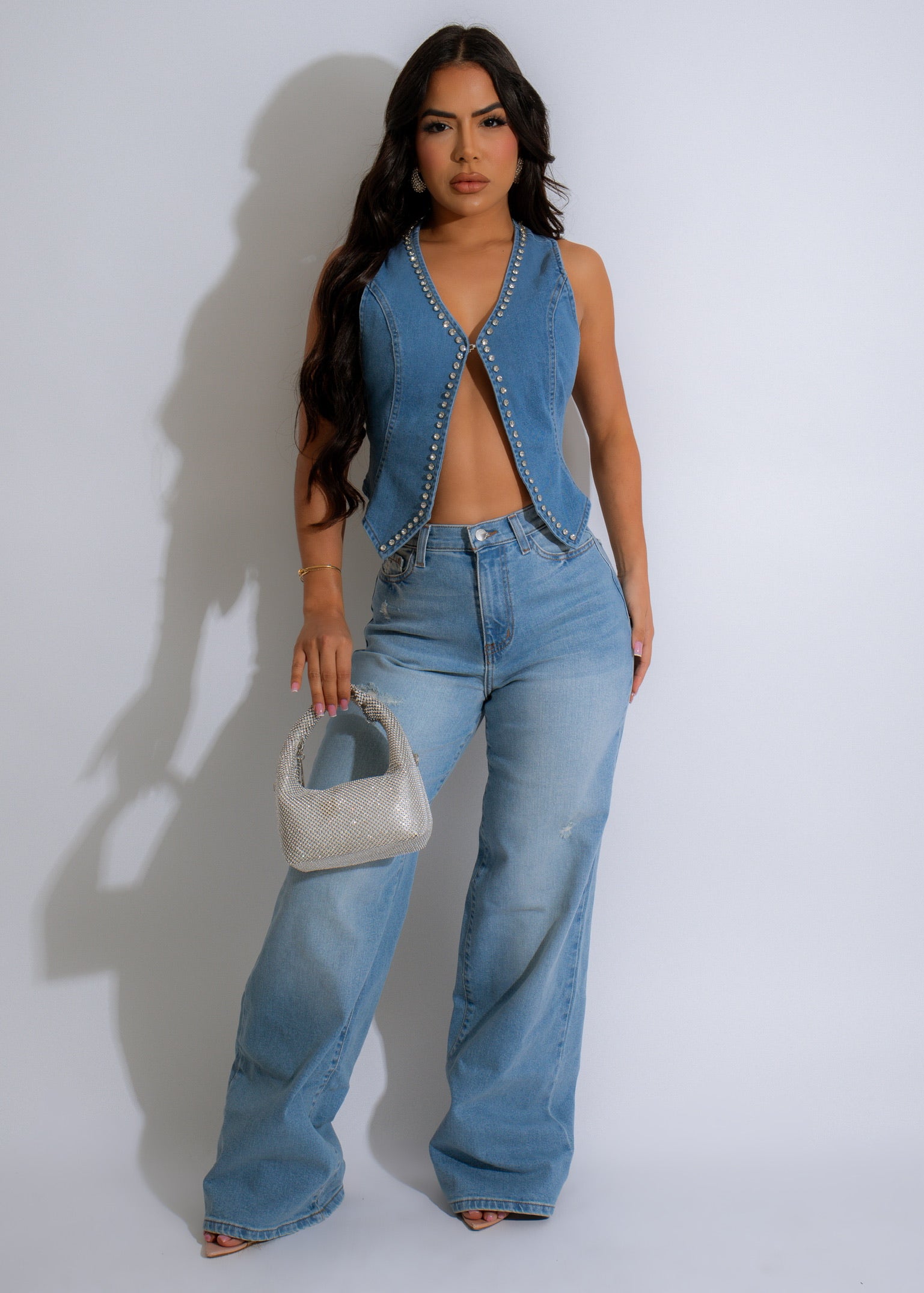 Stylish sleeveless vest top featuring shimmering rhinestones and a denim fabric