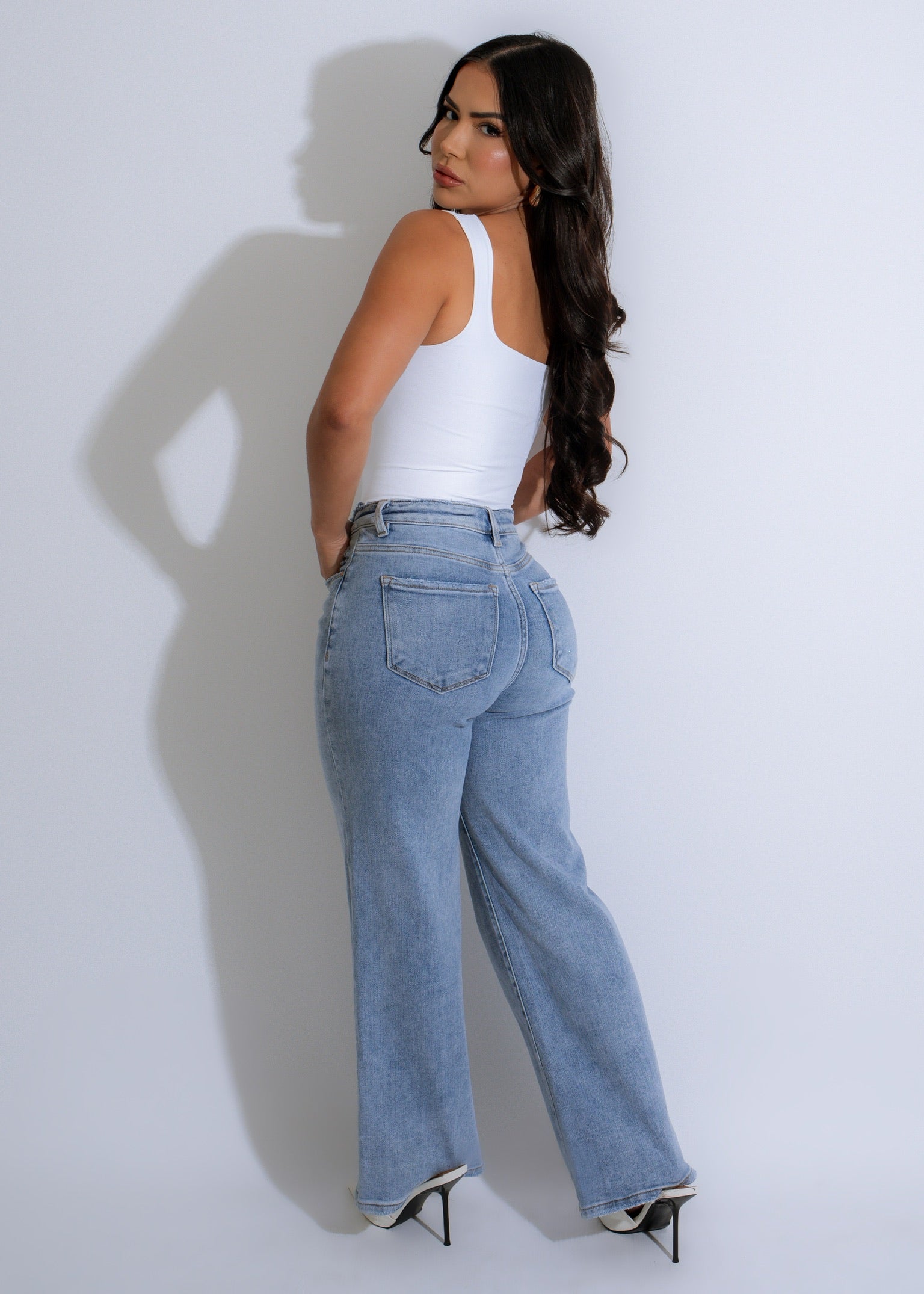 The Sculpt Square Bodysuit White, a versatile and stylish piece that can be worn on its own or layered with other clothing for a trendy look