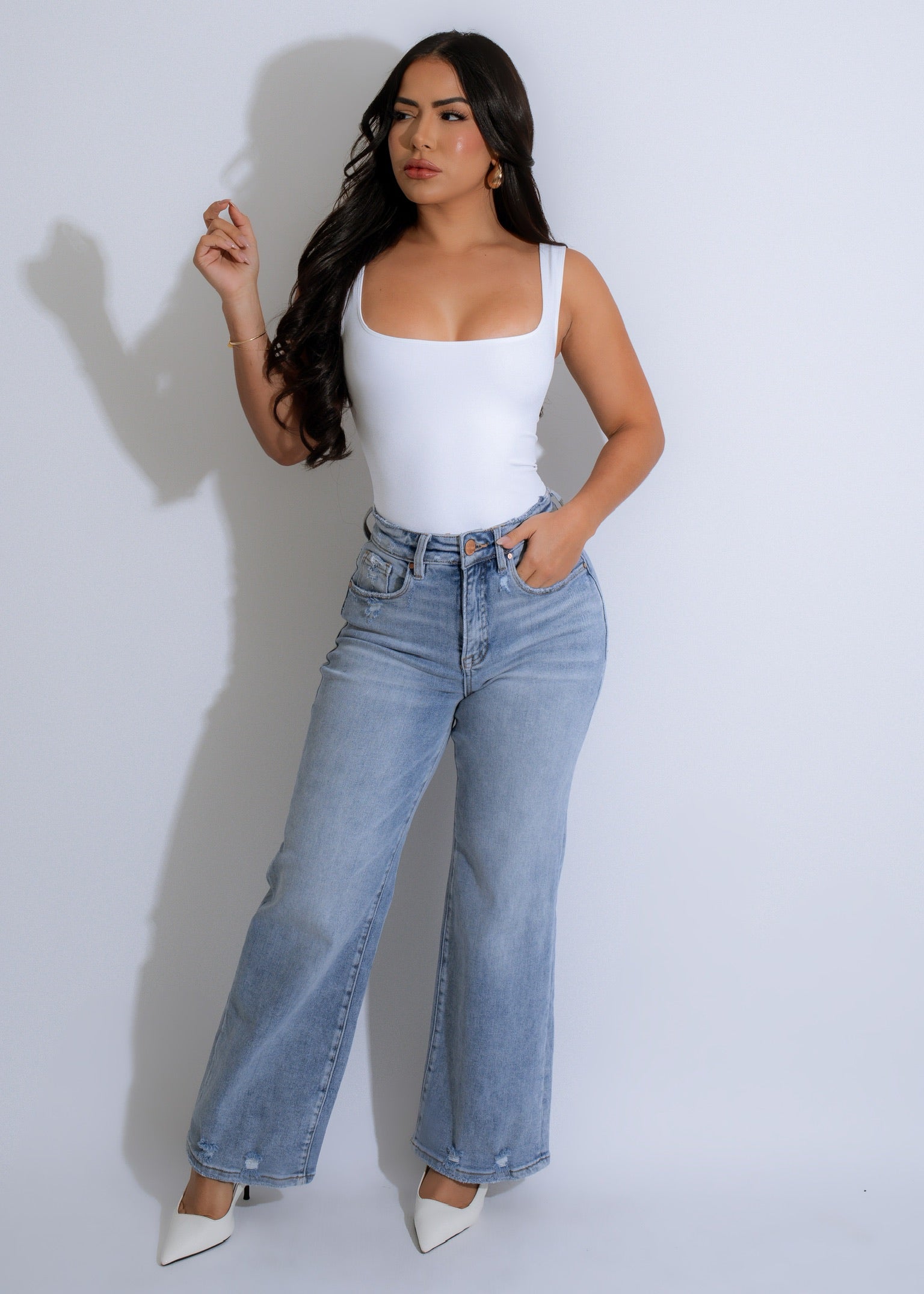 A close-up of the white bodysuit, highlighting the sleek and smooth fabric with a comfortable and flattering fit