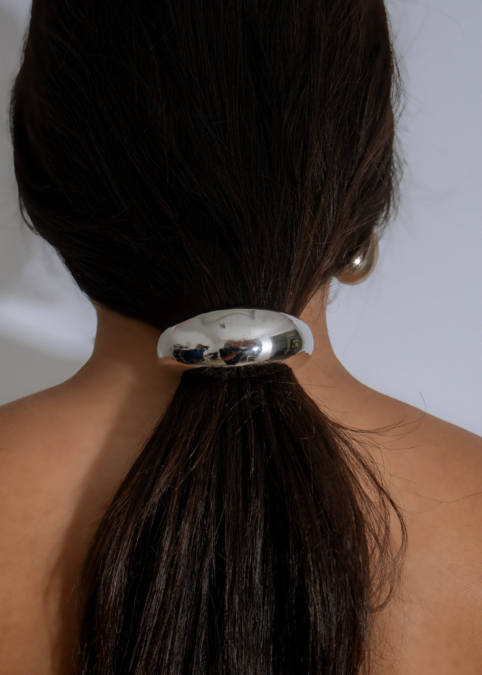 Crescent Glow Hair Tie Silver, a stylish and versatile accessory for any hair type or style