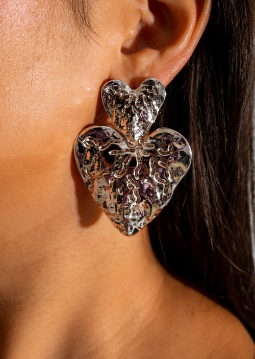 Shiny silver heart-shaped dangle earrings, a timeless and elegant accessory