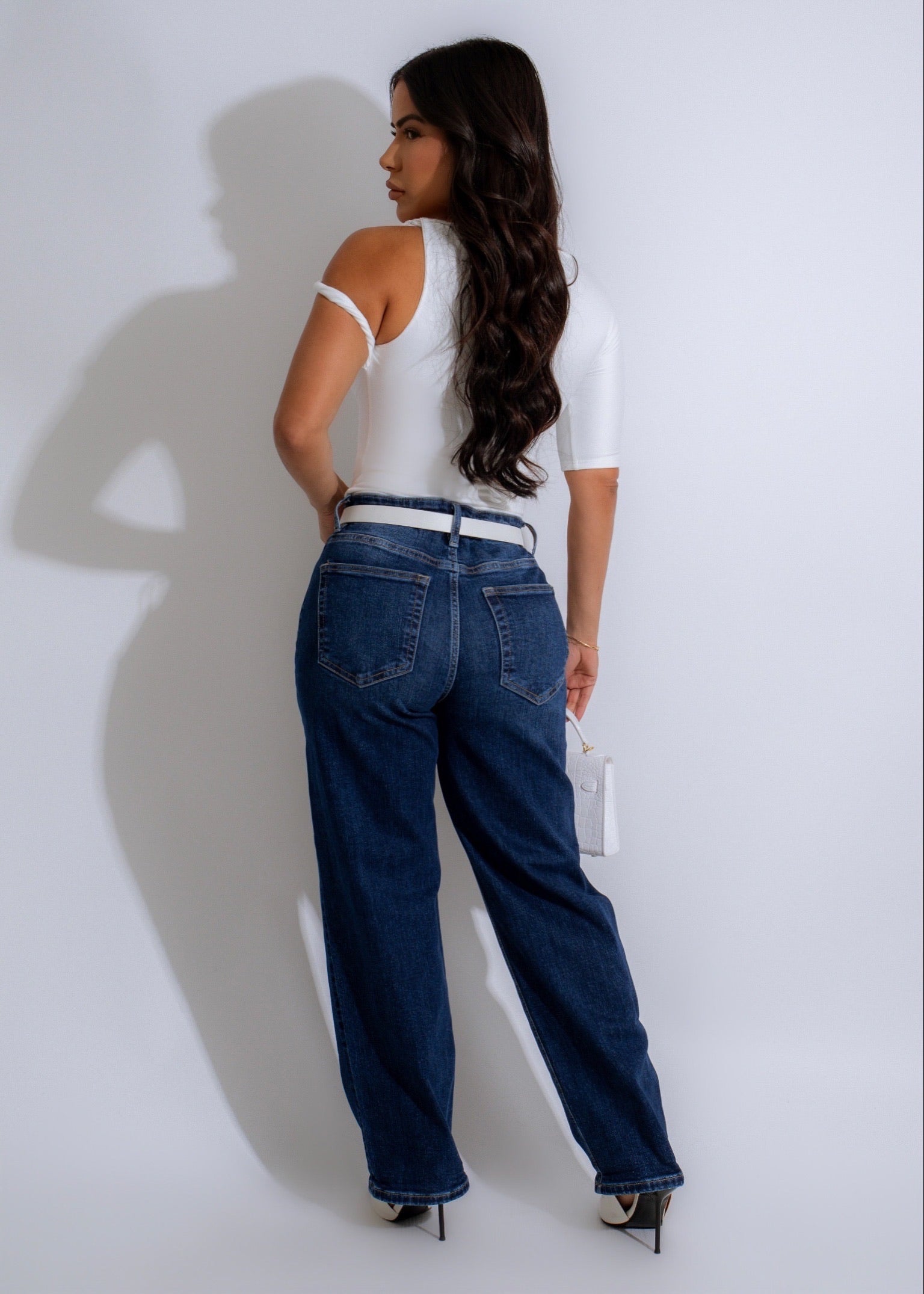 Model wearing Everlast high rise cuff jeans in dark denim with a white top