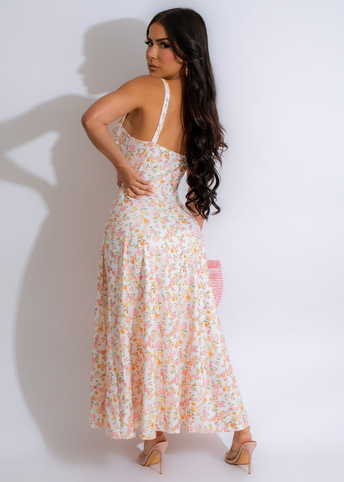 Beautiful white midi dress featuring a pastel floral print, perfect for a feminine and elegant look
