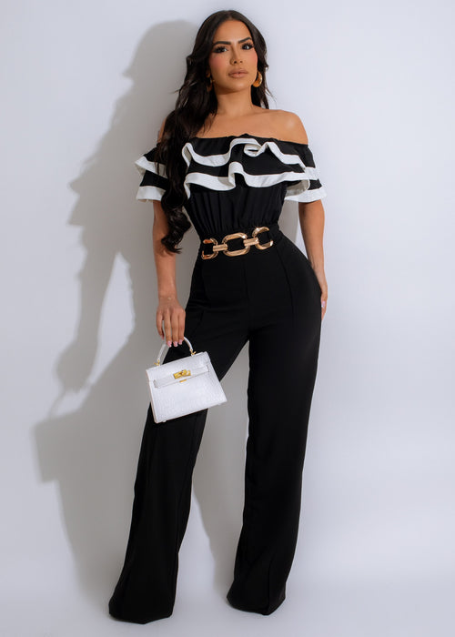 Black sleeveless jumpsuit with V-neck and tie waist, perfect for a night out or special occasion