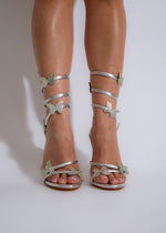 Shimmering silver rhinestone heels with butterfly embellishments for glamorous look