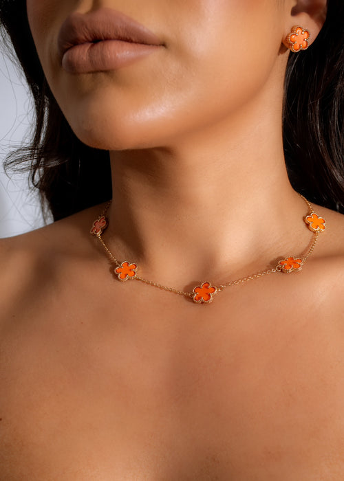 Close up of Be Honest Necklace Orange, a delicate and vibrant piece with intricate details and a unique charm, perfect for adding a pop of color to any outfit 