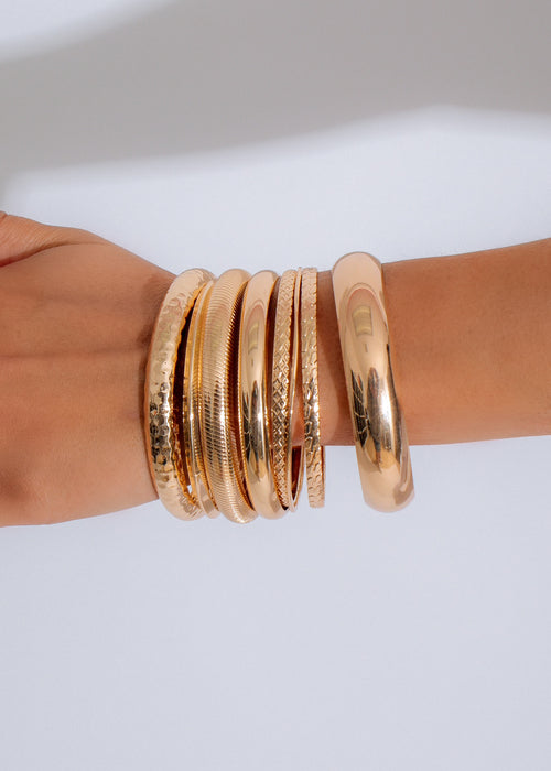 Shimmering gold bracelet set featuring delicate chains and intricate details