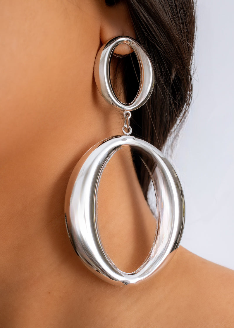 Shimmering silver earrings with intricate details, perfect for adding a touch of glamour to any outfit