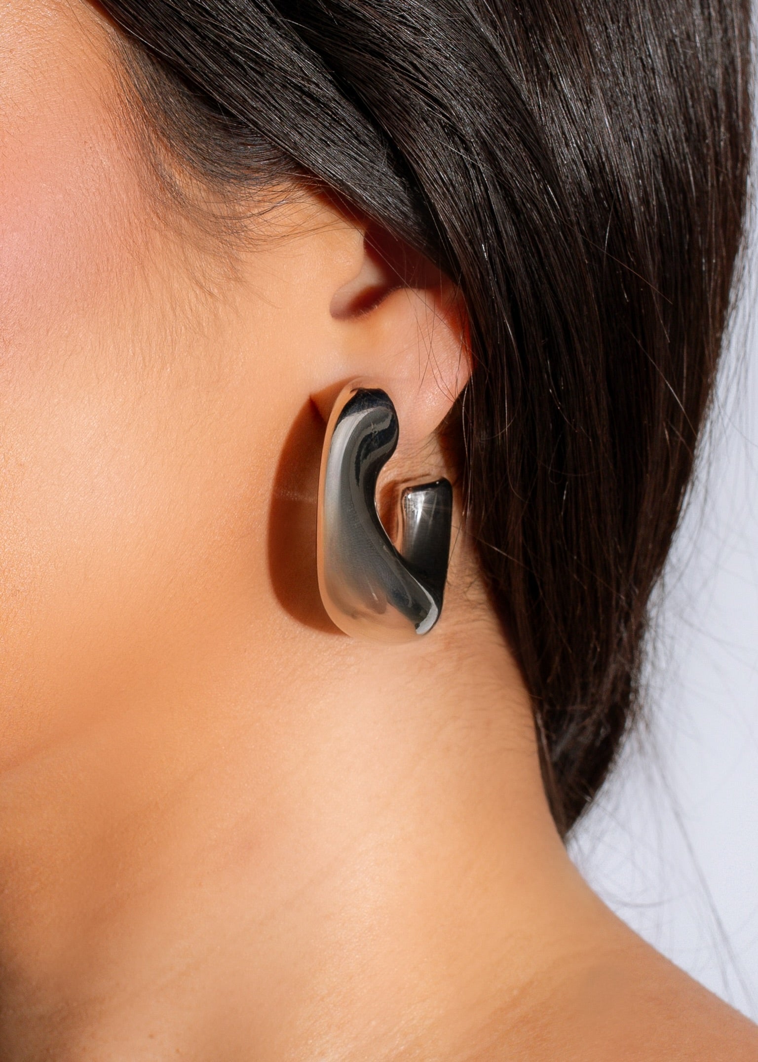 Shiny silver stud earring featuring a unique 'Stuck With Me' design