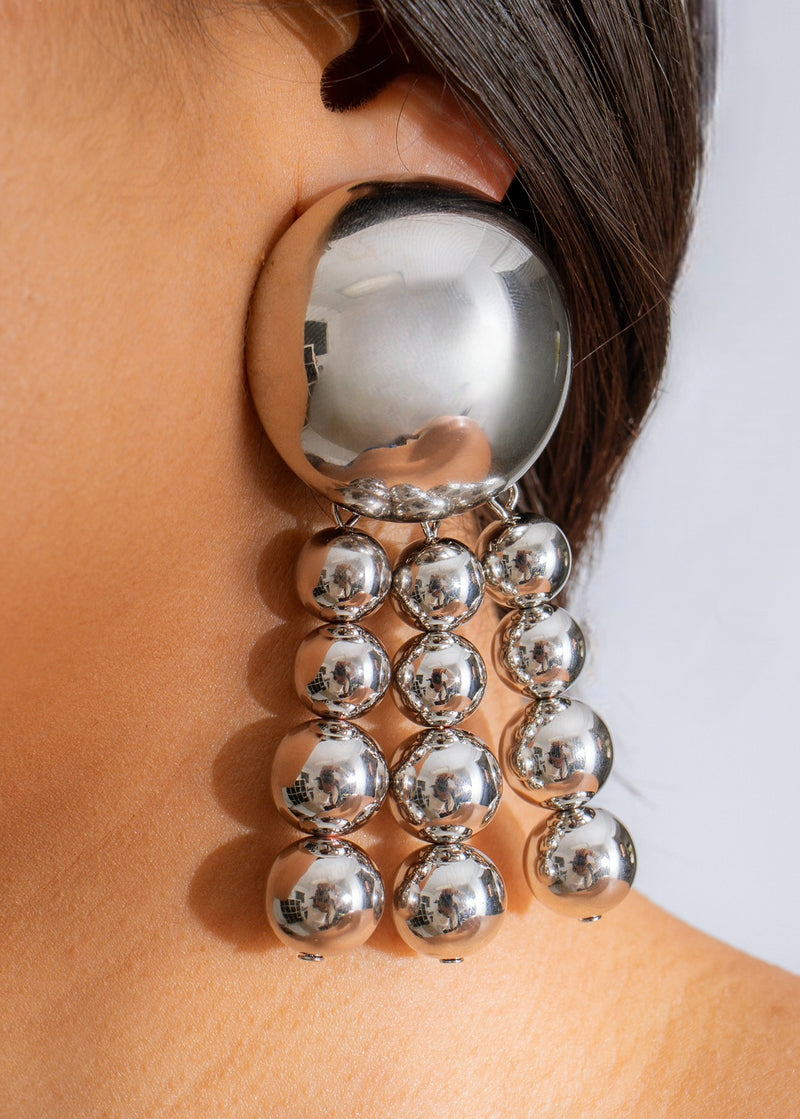Shiny silver earrings with a bold, strong design and intricate details