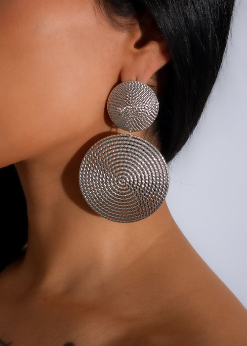 Shiny silver earrings with intricate design, perfect for adding glamour to any outfit