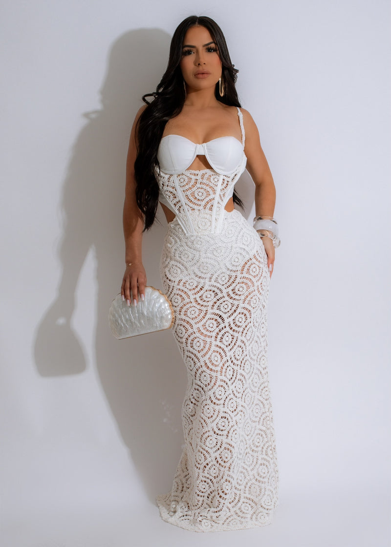 Beautiful white crochet maxi dress with intricate detailing and a flowy silhouette perfect for summer days under the sun 