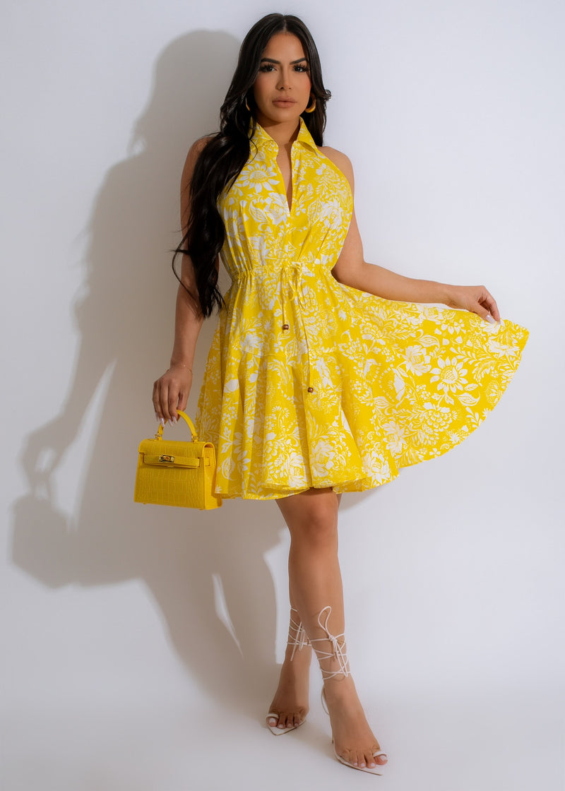 Close-up of yellow Floral Vibes Mini Dress with dainty floral pattern and ruffled hem