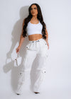 White parachute cargo pants with multiple pockets and a comfortable fit