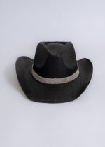 Black cowboy hat with rhinestone embellishments shining in the sunset