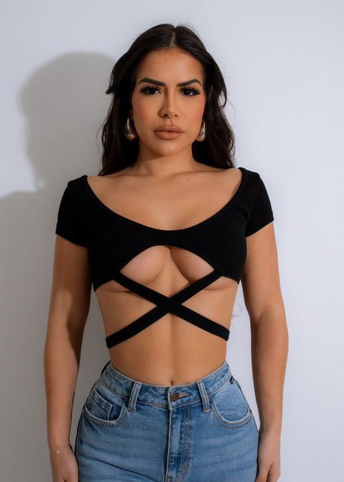 Close-up of a woman wearing a stylish and comfortable Mind Body Ribbed Crop Top in classic black color, showcasing the ribbed texture and body-hugging fit