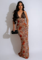 Close-up of brown lace maxi dress with intricate floral patterns and flowing skirt