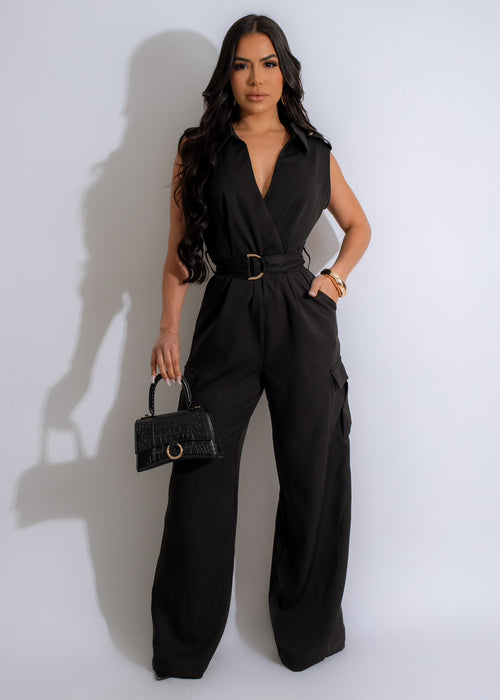 Beautiful woman in black cargo jumpsuit with stylish design and pockets