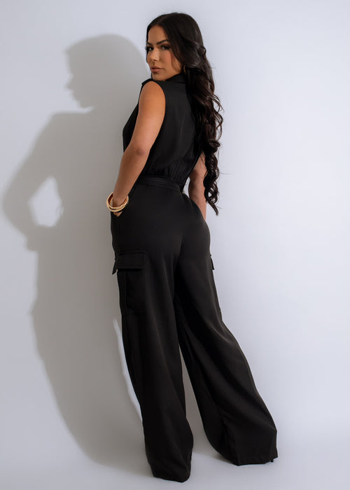 Fashionable woman wearing a black jumpsuit with cargo pockets and flattering silhouette