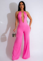 Just-Friends-Jumpsuit-Pink-hanging-on-a-rack-with-floral-pattern