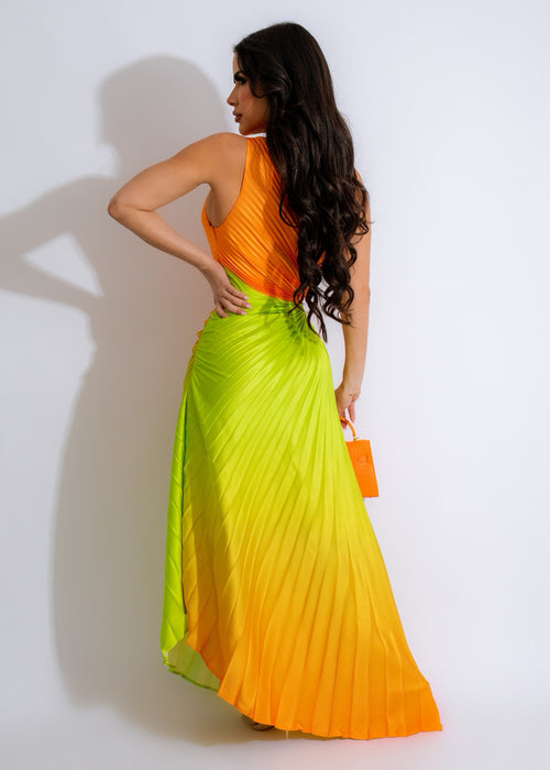 Close-up of a flowing orange silk maxi dress with ruched detailing