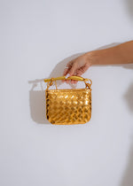 ###
A luxurious gold handbag with sparkling crystal embellishments and a sleek design