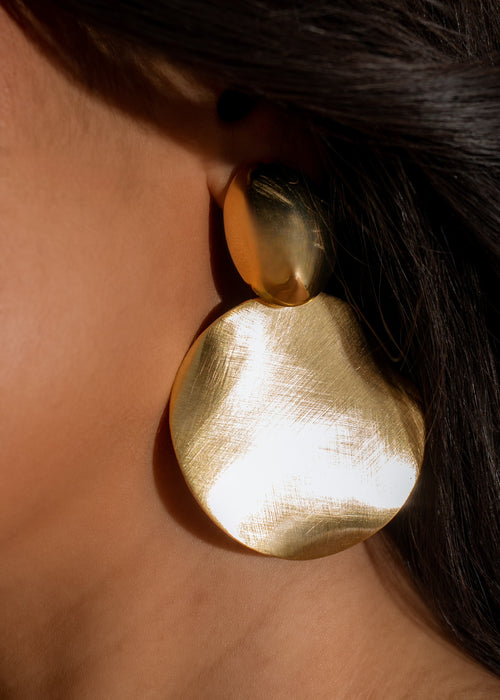 Beautiful gold earrings with intricate design, perfect for making a statement