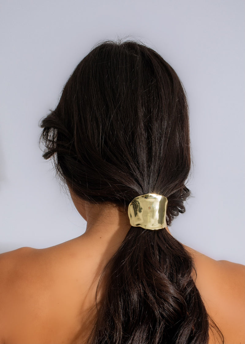 A close-up image of the She's A Classy Hair Tie Gold, a luxurious and elegant hair accessory with a shimmering gold finish, perfect for adding a touch of sophistication to any hairstyle