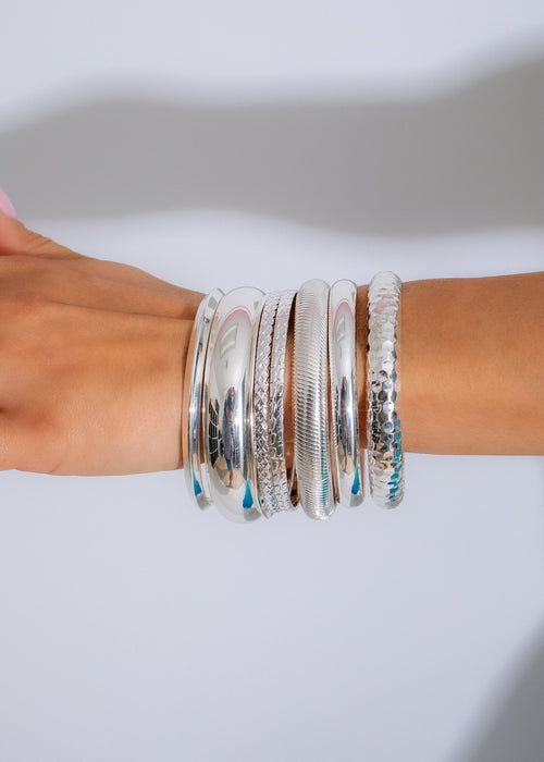 Set of silver bracelets with intricate designs, perfect for adding a touch of glamour