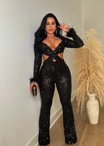 Full-length view of black feather jumpsuit with sequin accents