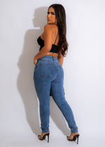 Dark blue denim jeans with intricate rhinestone embellishments featuring a crown and the word love in script font