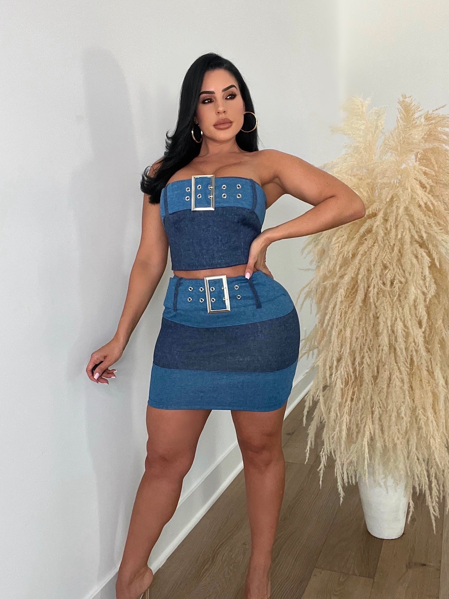 Front view of woman in denim skirt set with high-waisted fit and belt loops