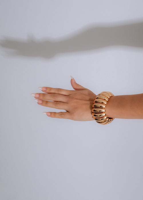 Shiny gold bracelet with asteroid-inspired design, perfect for adding glamour to any outfit