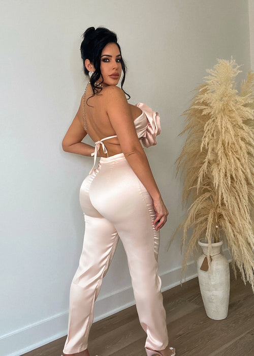 Two-piece satin pant set in a delicate nude color with a beautiful rose pattern, perfect for lounging in luxury and style