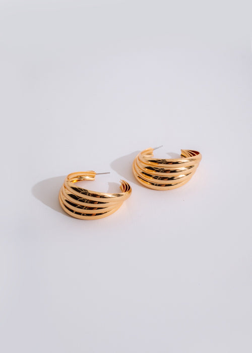  Gold statement earring with a long, dangling and eye-catching design