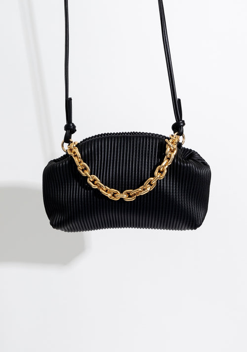 Close-up of the stylish Tell It Like It Is Handbag Black with gold hardware and adjustable strap for versatile wearing options