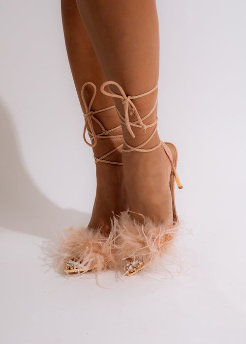 Stylish nude heel with a pointed toe and adjustable ankle strap