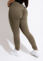 Close up of a woman wearing the high-waisted Diva Leggings in a rich olive green color, showcasing the comfortable and flattering fit