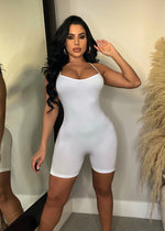 Alt text: A beautiful white romper with a flattering cinched waist and elegant v-neck design, perfect for any summer occasion