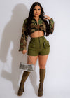 My Favorite Crop Camo Jacket Green on model standing in urban setting with graffiti background