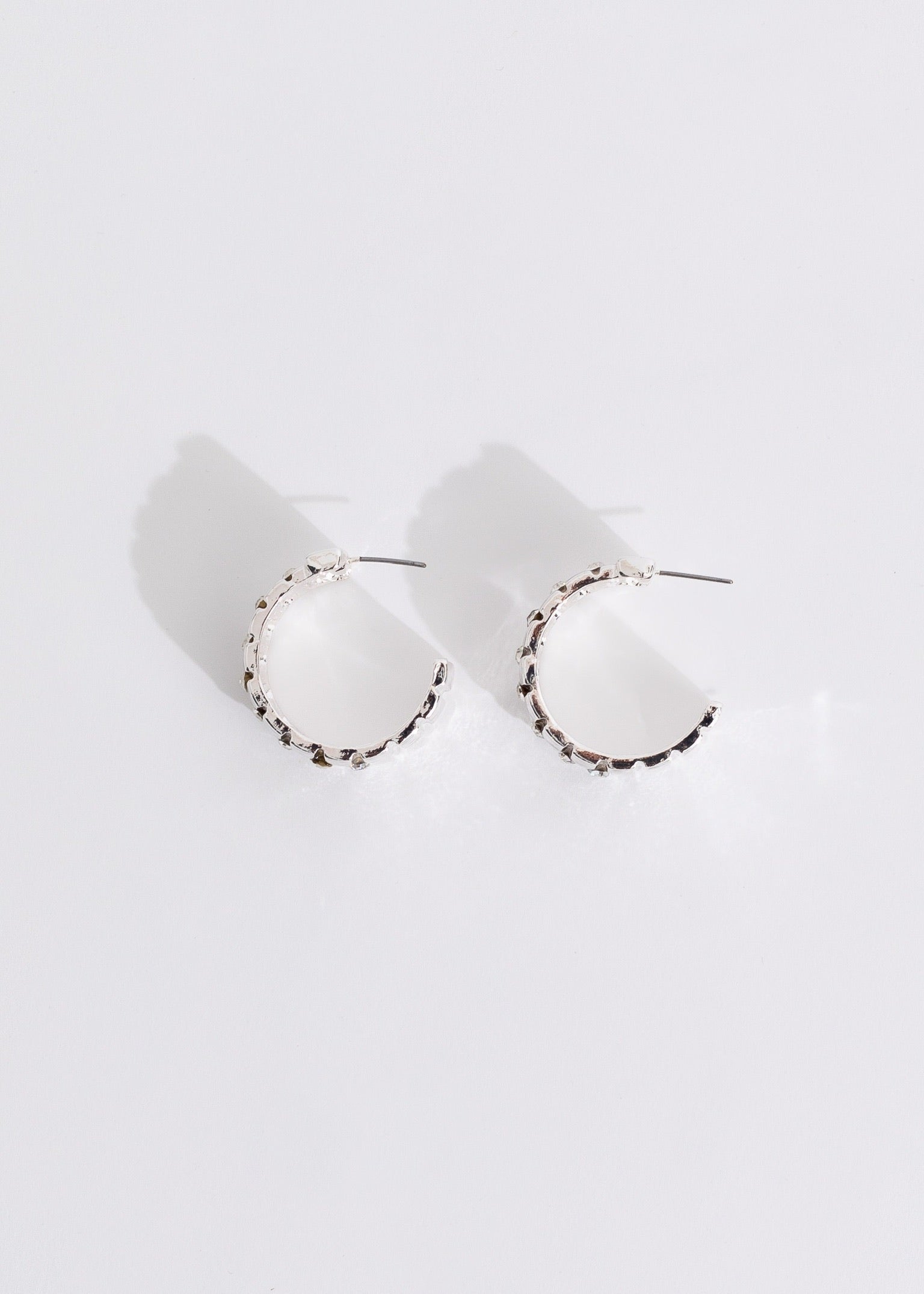 Shiny silver earrings with a unique design, perfect for elevating your style