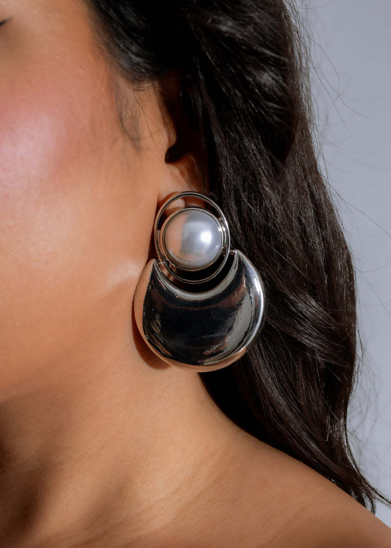 Beautiful silver earrings with a dangling pearl, perfect for adding elegance to any outfit