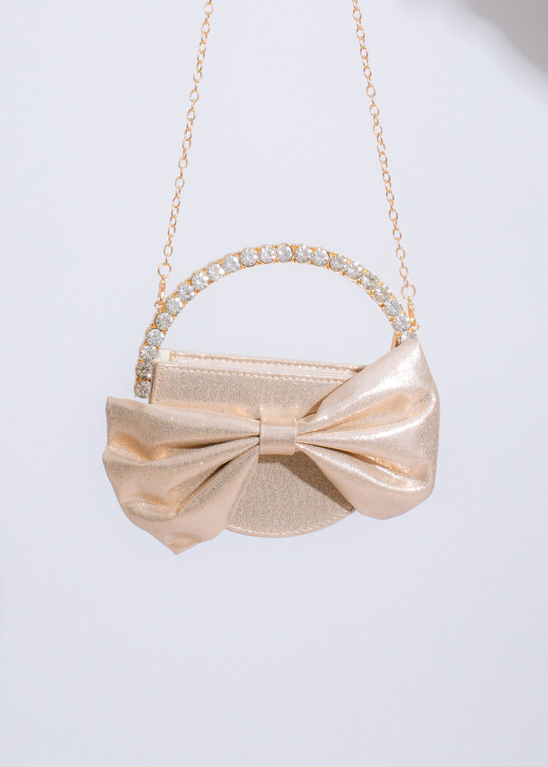  Chic and stylish Sweetest Girl Bow Handbag Gold featuring a timeless bow design and shimmering gold finish for a touch of glamour