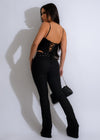 A long, elegant black lace jumpsuit, reminiscent of Hollywood glamour