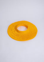 Yellow open straw hat with wide brim and black ribbon detail, perfect for sunny days at the beach or picnics in the park
