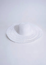 Stylish white luxury vacay hat with wide brim and black ribbon accent