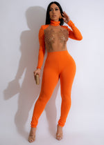 Close-up image of orange vinyl record mesh pearls jumpsuit with elegant design and flattering fit for women 