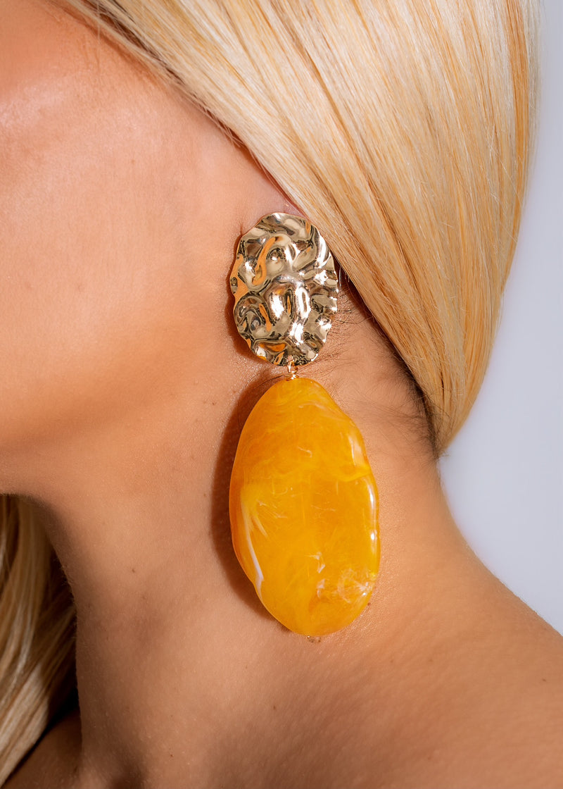 Pair of bright yellow dangle earrings with a warm, summery feel