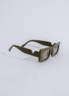Fashionable green square sunglasses perfect for a leisurely beach stroll