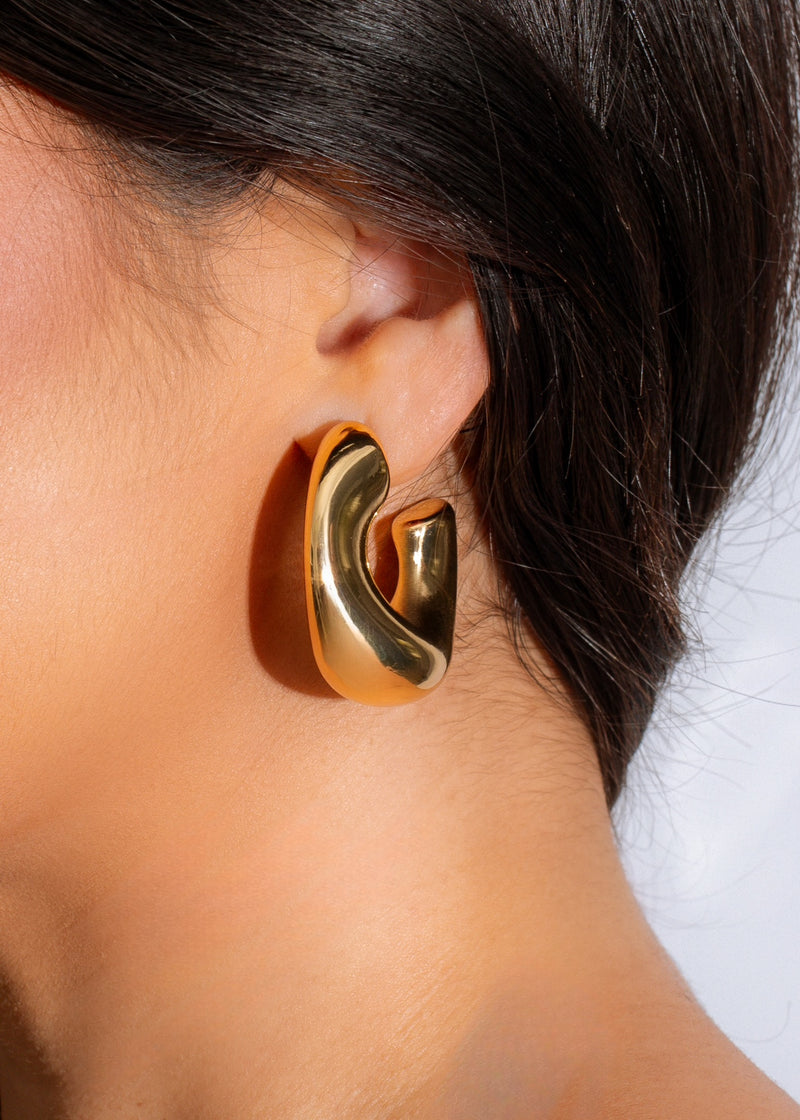 Shiny gold stud earring with a unique design, perfect for everyday wear